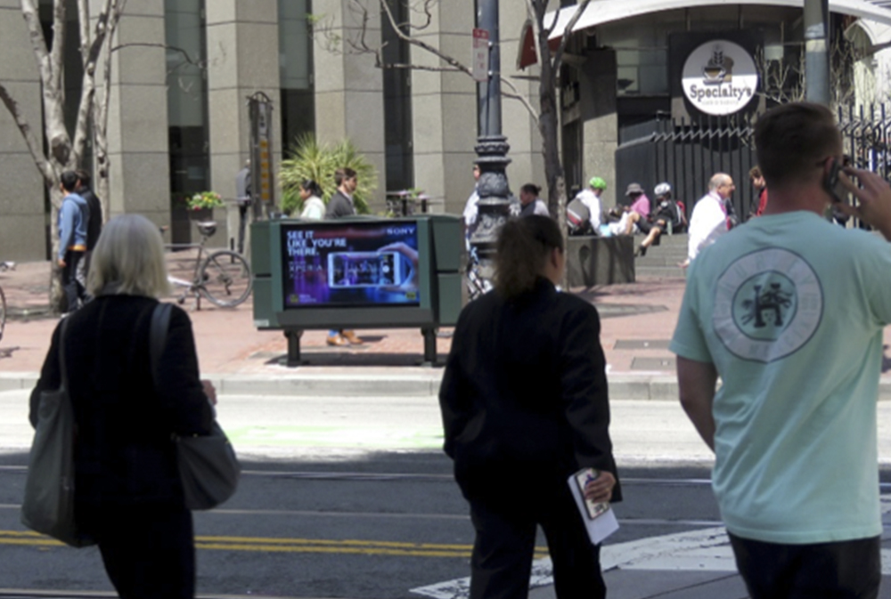 Sidewalk advertising panel targeting shoppers near national retailers