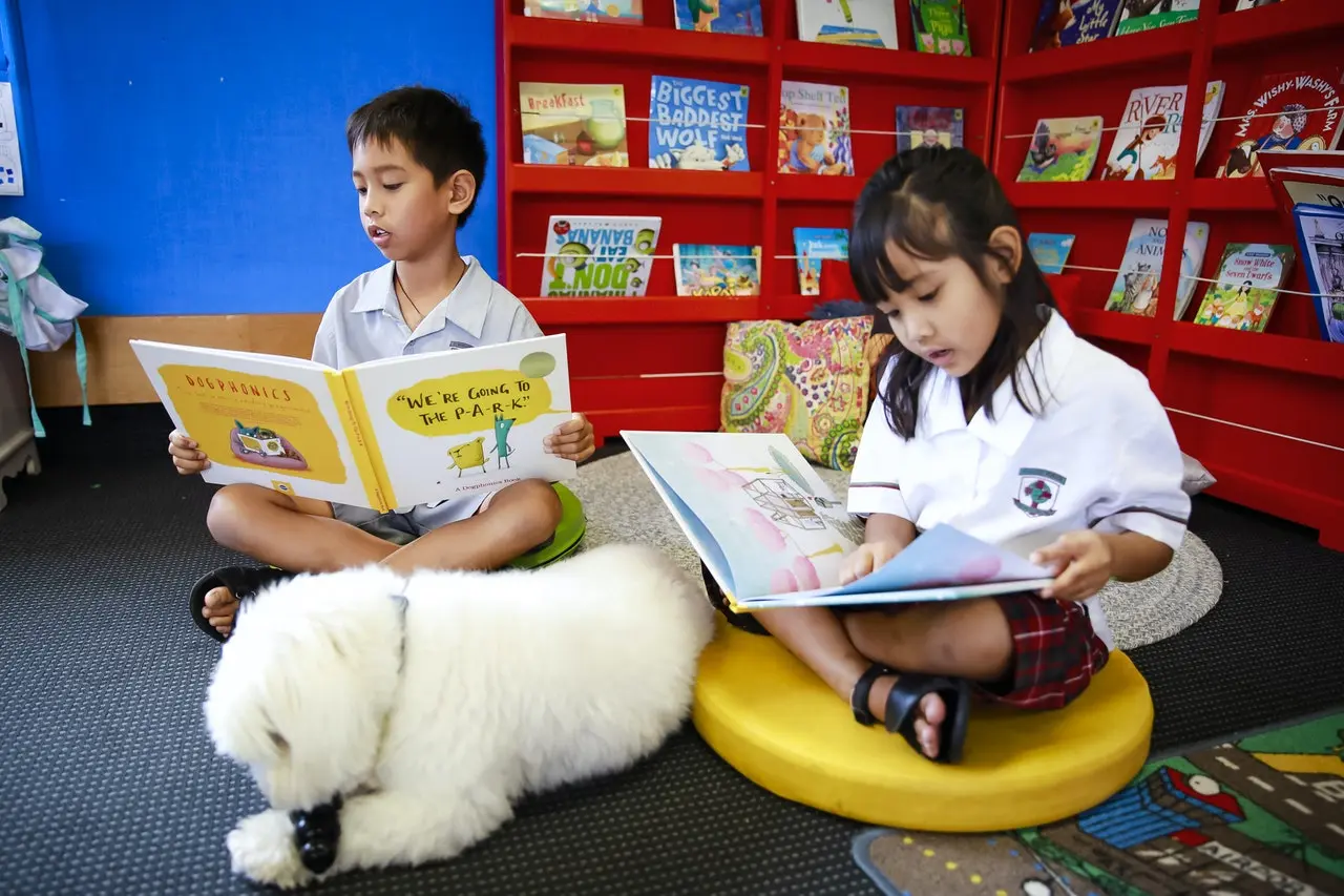 Children in New Zealand reading Dogphonics book with their Dog
